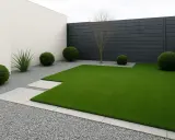 Modern garden with artificial grass, gravel, concrete paths and spherical bushes. Ideas para jardin con cesped artificial.