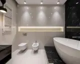 Radiador toallero blanco colgado en pared junto a un inodoro y bidet, ideal para baños modernos.