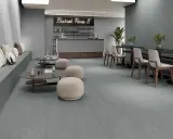 Modern café con suelo de baldosas grises, asientos de banco, mesas bajas y sillas. Ideal para aprender como colocar baldosas en el suelo.