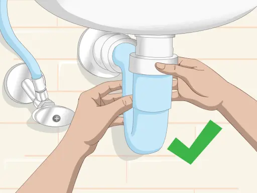Manos ajustando el sifón azul del lavabo. Un símbolo de verificación verde indica que la tarea de cambiar sifón lavabo está completa.